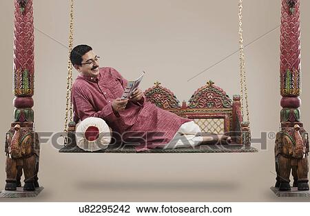 South Indian man reading a magazine View Large Photo Image Stock Image - South Indian man reading a magazine . Fotosearch