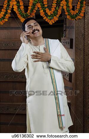 South Indian man talking on a mobile phone View Large Photo Image Stock Image - South Indian man talking on a mobile phone . Fotosearch