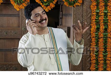 South Indian man talking on a mobile phone View Large Photo Image Stock Image - South Indian man talking on a mobile phone . Fotosearch