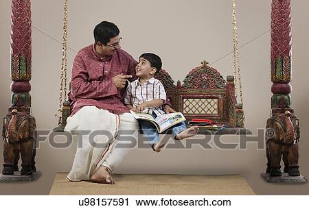 South Indian man teaching his son View Large Photo Image Stock Image - South Indian man teaching his son . Fotosearch