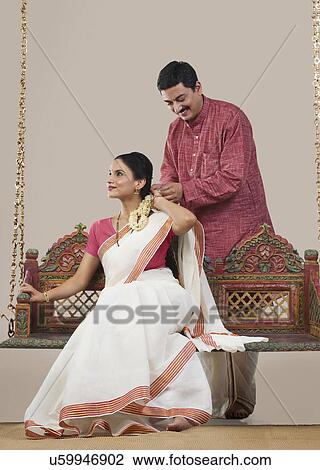 South Indian man tying a Gajra on his wife's hair View Large Photo Image Stock Image - South Indian man tying a Gajra on his wife's hair . Fotosearch