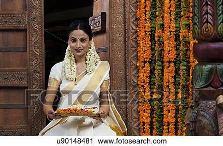 South Indian woman holding a tray View Large Photo Image Stock Image - South Indian woman holding a tray . Fotosearch