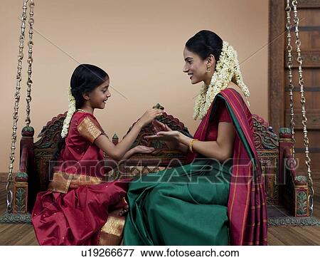 Stock Photo - South Indian woman playing with her daughter . Fotosearch