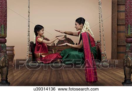 South Indian woman playing with her daughter View Large Photo Image Stock Photograph - South Indian woman playing with her daughter . Fotosearch