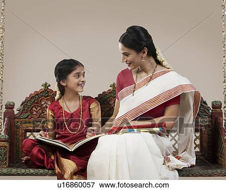 South Indian woman sitting with her daughter View Large Photo Image Stock Photo - South Indian woman sitting with her daughter . Fotosearch