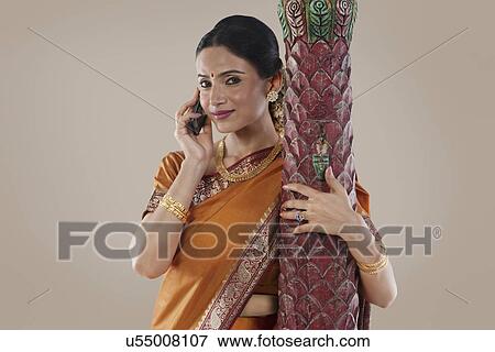Stock Photo - South Indian woman talking on a mobile phone . Fotosearch