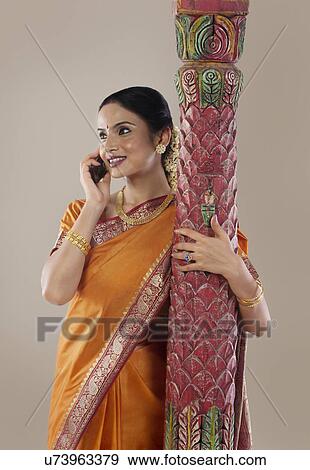 South Indian woman talking on a mobile phone View Large Photo Image Stock Photo - South Indian woman talking on a mobile phone . Fotosearch