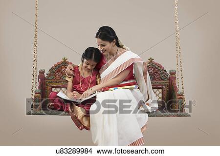 South Indian woman teaching her daughter View Large Photo Image Picture - South Indian woman teaching her daughter . Fotosearch