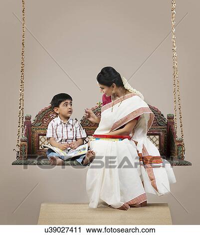 South Indian woman teaching her son View Large Photo Image Stock Image - South Indian woman teaching her son . Fotosearch