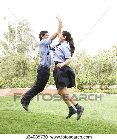 Students doing a hi-five in the air View Large Photo Image Stock Image - Students doing a hi-five in the air . Fotosearch