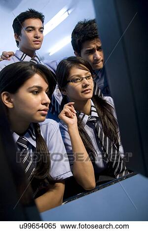 Stock Photography - Students looking at a computer screen . Fotosearch