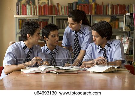 Students sitting in a school library View Large Photo Image Stock Image - Students sitting in a school library . Fotosearch