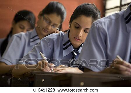 Students writing in a classroom View Large Photo Image Stock Photo - Students writing in a classroom . Fotosearch