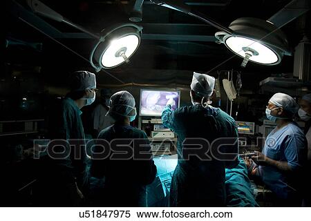 Surgeon looking at an operating screen View Large Photo Image Stock Photography - Surgeon looking at an operating screen . Fotosearch