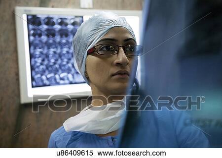 Surgeon looking at an X-ray chart View Large Photo Image Stock Photography - Surgeon looking at an X-ray chart . Fotosearch