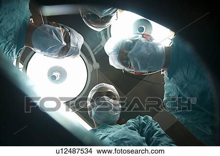 Picture - Surgeons in an operation theatre . Fotosearch