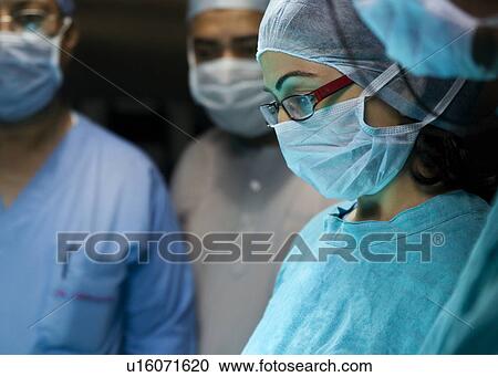 Surgeons in an operation theatre View Large Photo Image Stock Image - Surgeons in an operation theatre . Fotosearch