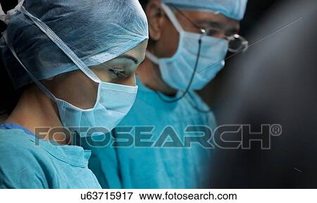 Surgeons in an operation theatre View Large Photo Image Stock Photo - Surgeons in an operation theatre . Fotosearch
