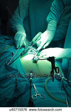 Surgeons performing an operation in the ICU View Large Photo Image Stock Photograph - Surgeons performing an operation in the ICU . Fotosearch
