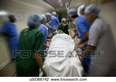 Surgeons rushing a patient to an operation theatre View Large Photo Image Stock Image - Surgeons rushing a patient to an operation theatre . Fotosearch
