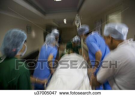 Surgeons rushing a patient to an operation theatre  View Large Photo Image Stock Photo - Surgeons rushing a patient to an operation theatre . Fotosearch