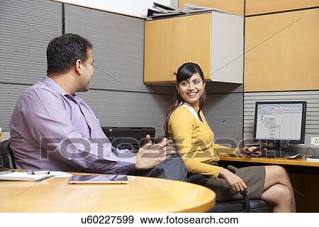 Two business executives talking in an office View Large Photo Image Stock Photo - Two business executives talking in an office. Fotosearch