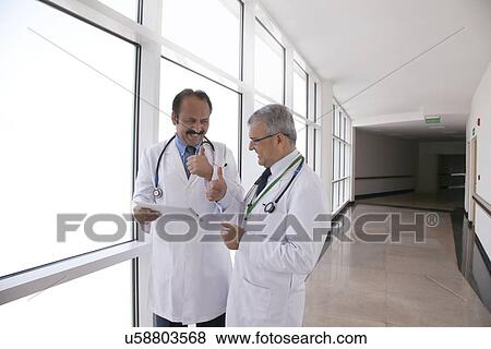 Two doctors giving thumbs up View Large Photo Image Stock Photo - Two doctors giving thumbs up. Fotosearch
