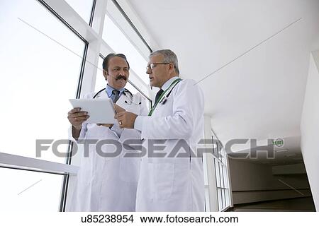 Picture - Two doctors with a digital tablet. Fotosearch