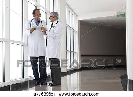 Two doctors with a digital tablet smiling View Large Photo Image Stock Image - Two doctors with a digital tablet smiling. Fotosearch