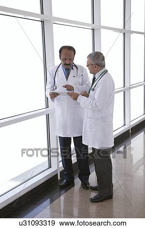 Two doctors with a digital tablet View Large Photo Image Stock Photo - Two doctors with a digital tablet. Fotosearch