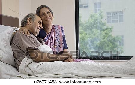 Wife sitting with her husband in the hospital View Large Photo Image Stock Photo - Wife sitting with her husband in the hospital . Fotosearch