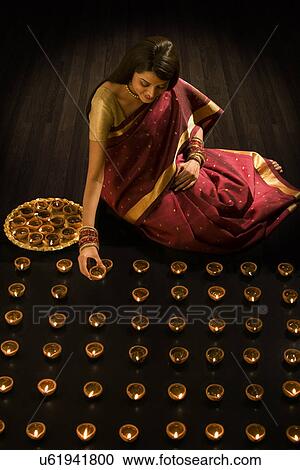 Woman arranging diyas View Large Photo Image Stock Image - Woman arranging diyas . Fotosearch
