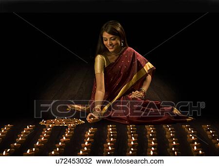 Woman arranging diyas View Large Photo Image Stock Image - Woman arranging diyas . Fotosearch