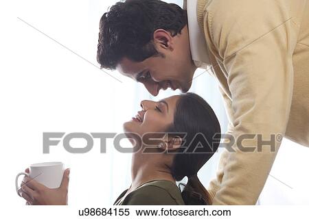 Stock Photography - Woman awaiting a kiss from a man. Fotosearch