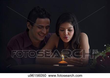 Woman blowing out a candle in a muffin View Large Photo Image Stock Image - Woman blowing out a candle in a muffin. Fotosearch