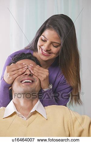 Woman covering mans eyes with her hands View Large Photo Image Stock Photo - Woman covering mans eyes with her hands. Fotosearch