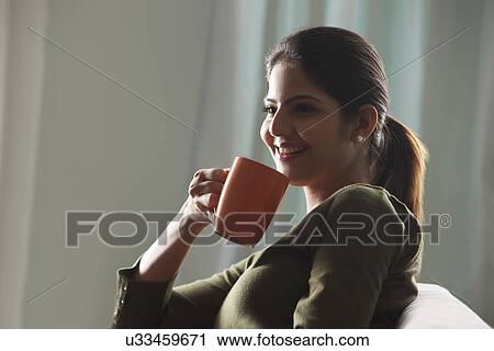 Woman drinking tea View Large Photo Image Stock Image - Woman drinking tea. Fotosearch
