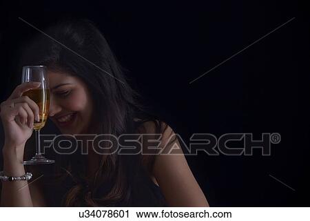 Stock Image - Woman enjoying a glass of wine. Fotosearch