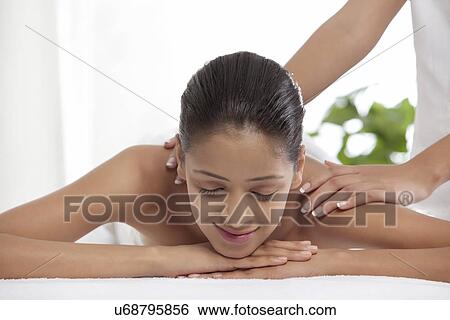 Stock Photograph - Woman getting a back massage at spa . Fotosearch