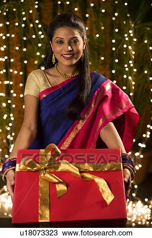 Woman holding a diwali gift View Large Photo Image Stock Image - Woman holding a diwali gift . Fotosearch