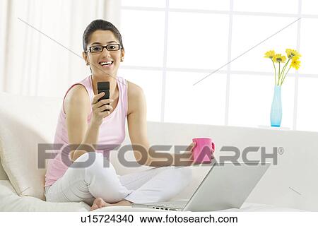 Woman holding a mobile phone View Large Photo Image Stock Image - Woman holding a mobile phone . Fotosearch