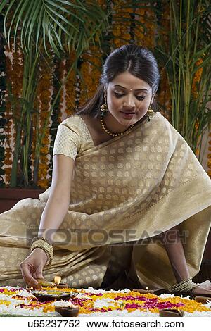 Woman lighting a diya View Large Photo Image Stock Image - Woman lighting a diya . Fotosearch