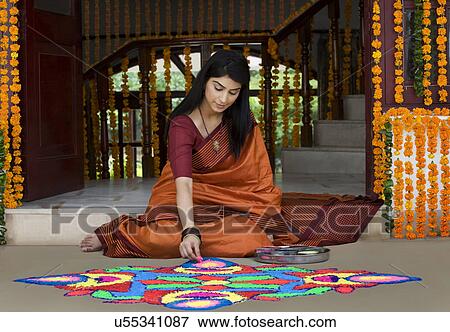 Woman making a rangoli View Large Photo Image Stock Photo - Woman making a rangoli . Fotosearch