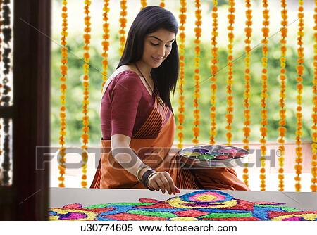 Stock Photography - Woman making a rangoli . Fotosearch