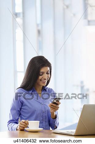 Woman reading an sms on a mobile phone View Large Photo Image Stock Image - Woman reading an sms on a mobile phone . Fotosearch