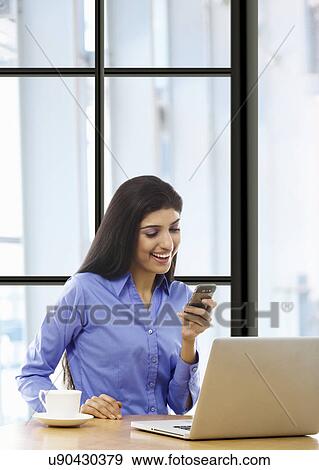 Woman reading an sms on a mobile phone View Large Photo Image Stock Photo - Woman reading an sms on a mobile phone . Fotosearch