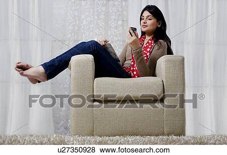 Woman reading an sms on her mobile phone View Large Photo Image Stock Photo - Woman reading an sms on her mobile phone . Fotosearch