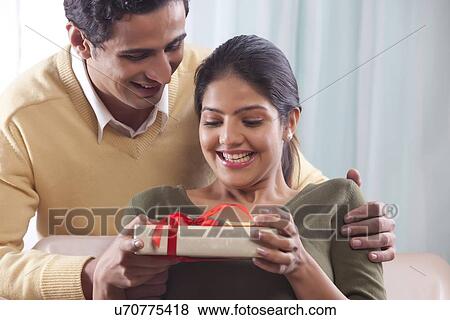 Woman receiving a gift on Valentines Day View Large Photo Image Stock Photo - Woman receiving a gift on Valentines Day. Fotosearch