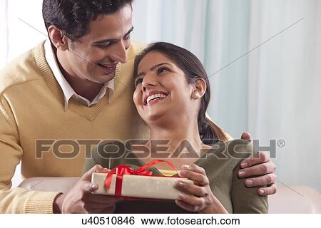 Woman receiving a gift on Valentines Day View Large Photo Image Stock Photograph - Woman receiving a gift on Valentines Day. Fotosearch