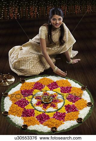 Woman sitting next to a rangoli View Large Photo Image Stock Photograph - Woman sitting next to a rangoli . Fotosearch